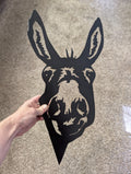 Hand holding the 17.5 inch black metal donkey head peeker to show its size