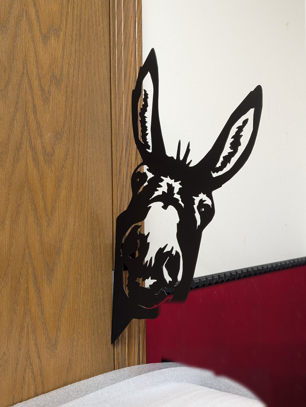 Angled view of the donkey peeker mounted on an edge