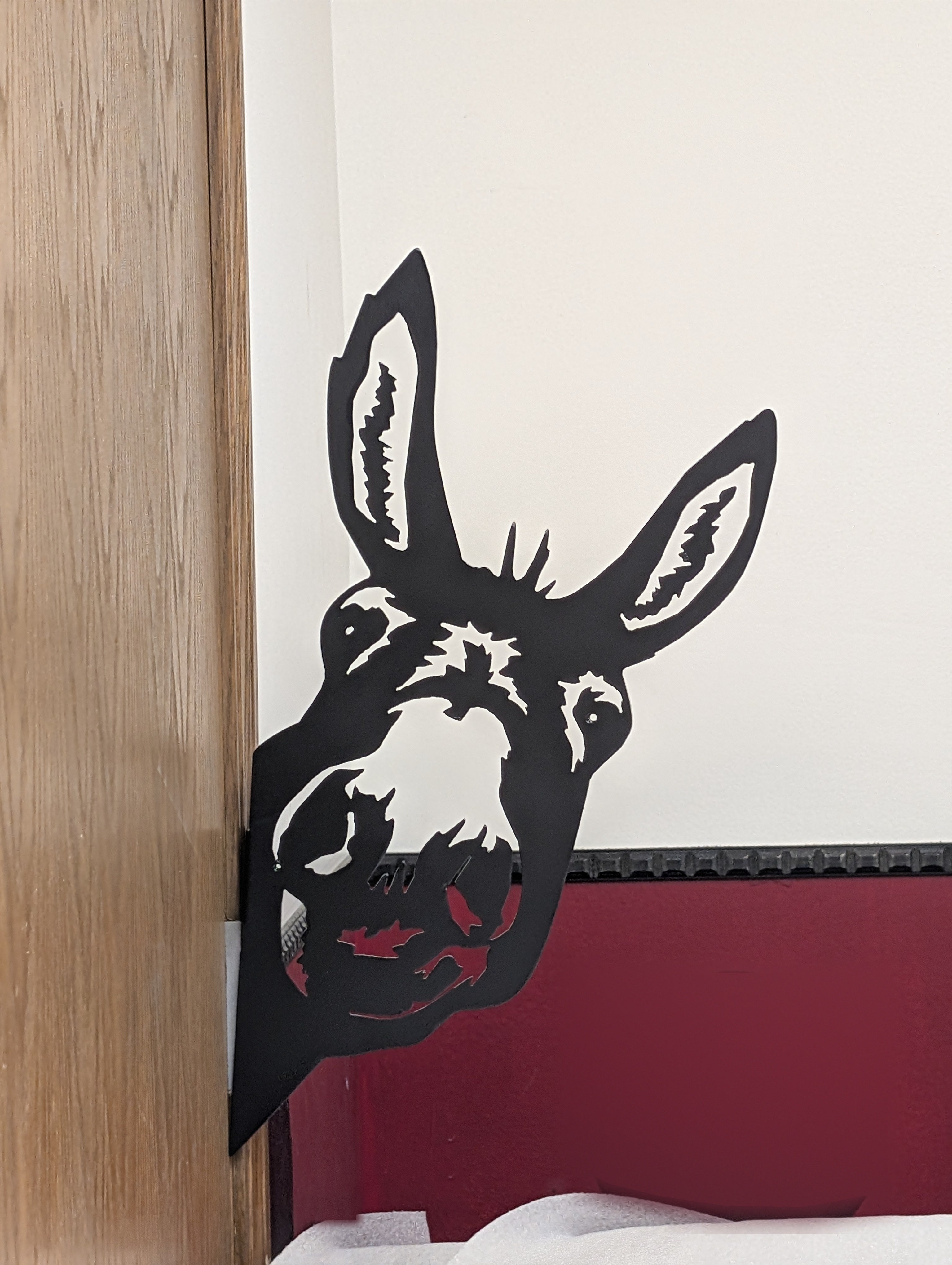 Donkey head peeking around a corner, mounted on the hidden bracket