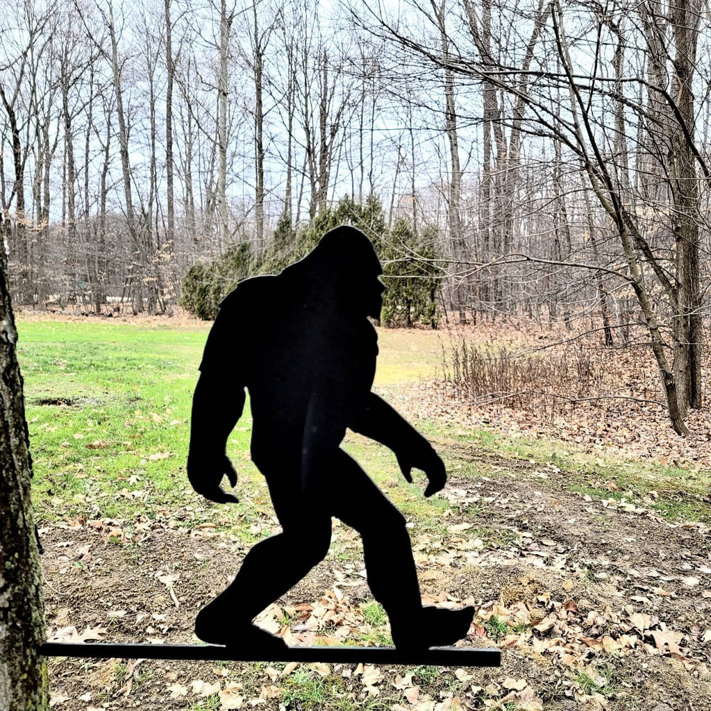 Bigfoot Silhouette Metal Garden Stake Metal Garden Stake — shown on a rustic wall