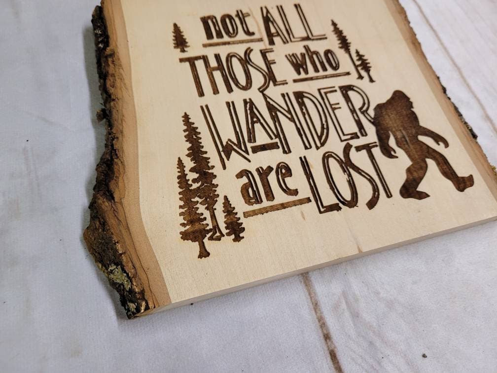 Laser Engraved Bigfoot on Live Edge Basswood  Wood Sign — shown on a rustic wall