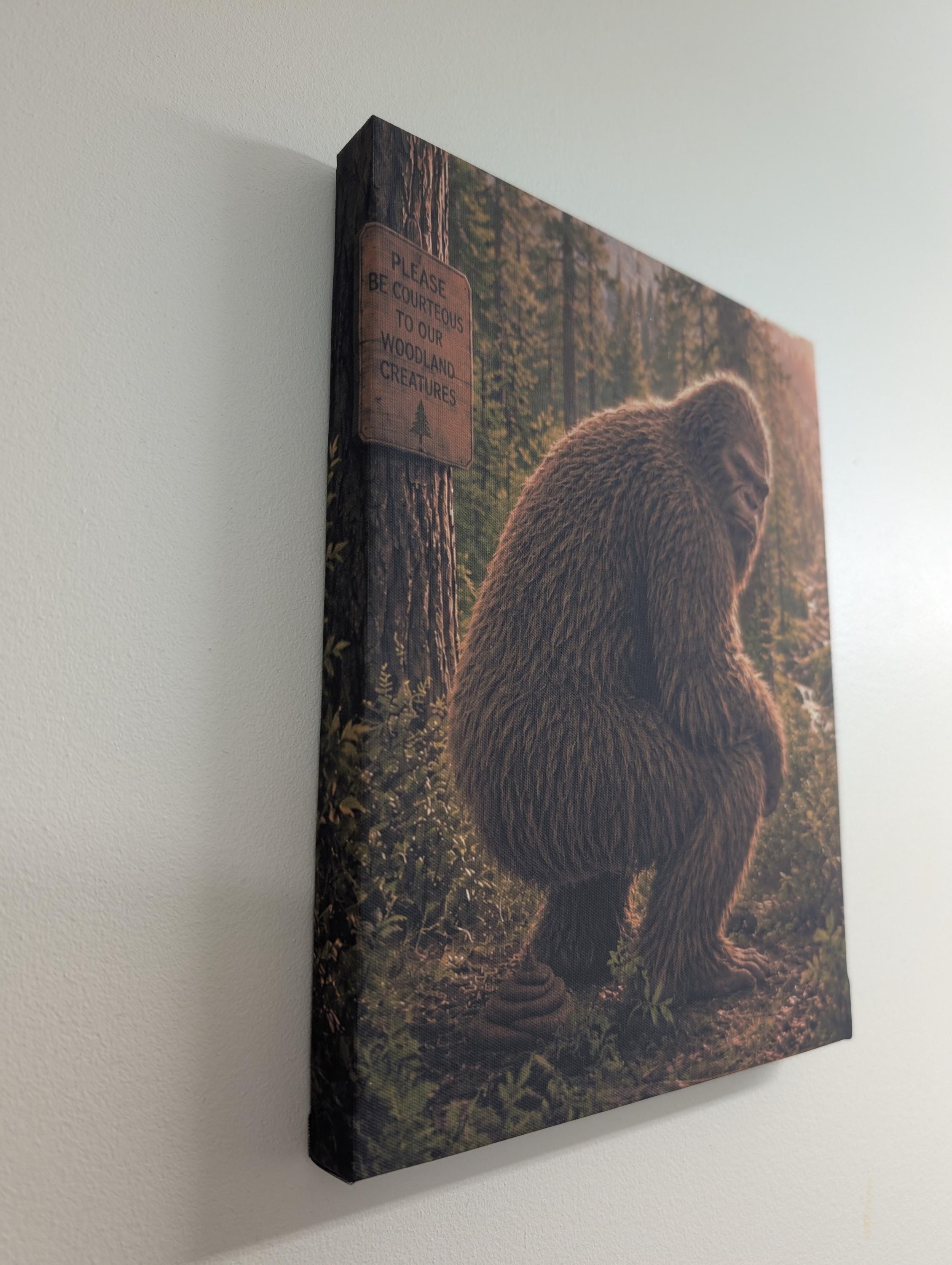 Squatting Bigfoot Canvas Print Canvas Print — shown on a rustic wall