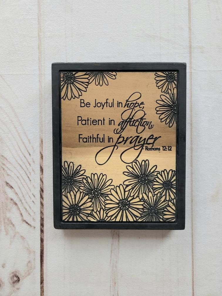 Romans 12:12 Scripture Christian Wood Sign Wood Sign — shown on a rustic wall