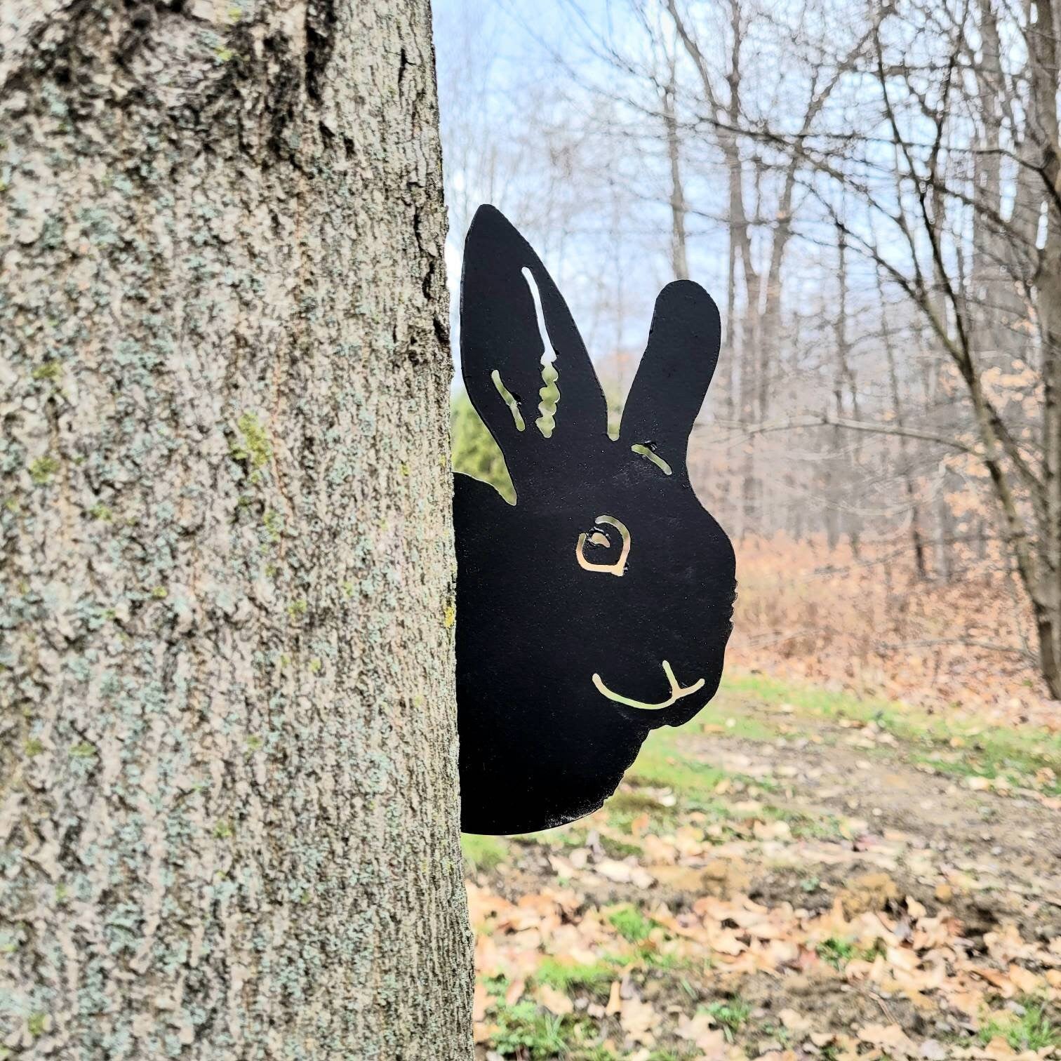 Peeking Bunny Metal Garden Stake Metal Garden Stake — shown on a rustic wall