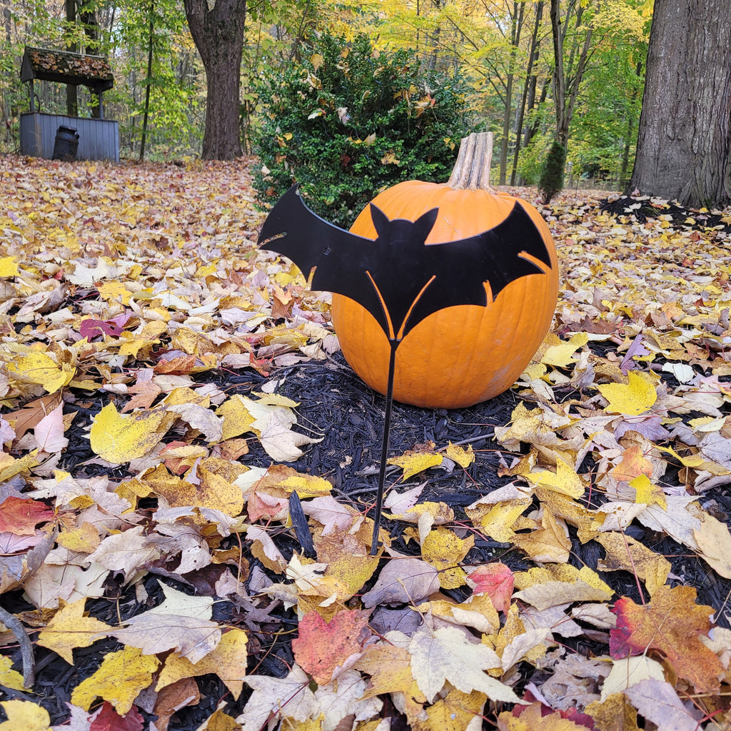 Spooky Bat Metal Garden Stake Metal Garden Stake — shown on a rustic wall
