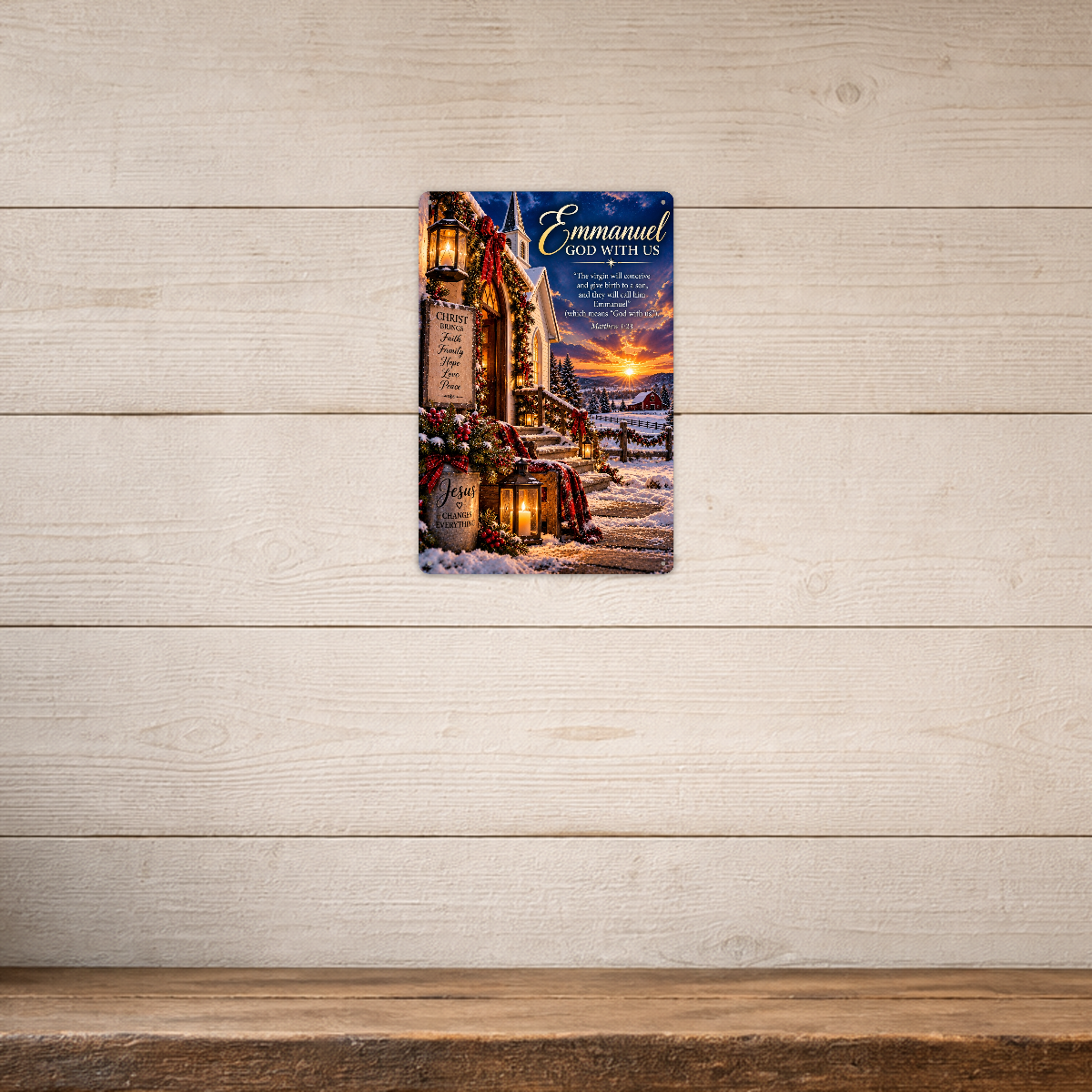 The aluminum sign showing a snowy church with an Emmanuel, God With Us sign, mounted on a light shiplap-paneled wall.