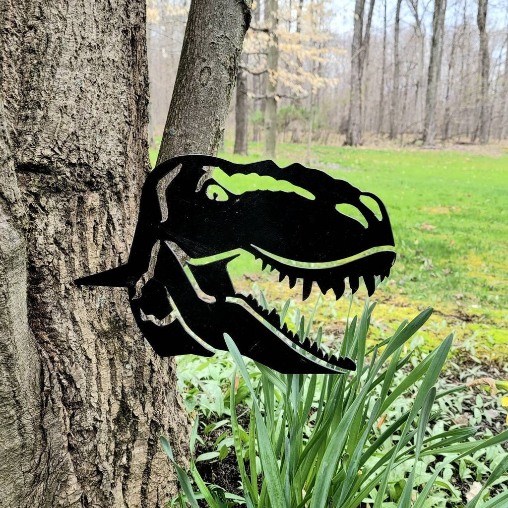 T-Rex Dinosaur Metal Garden Stake Metal Garden Stake — shown on a rustic wall