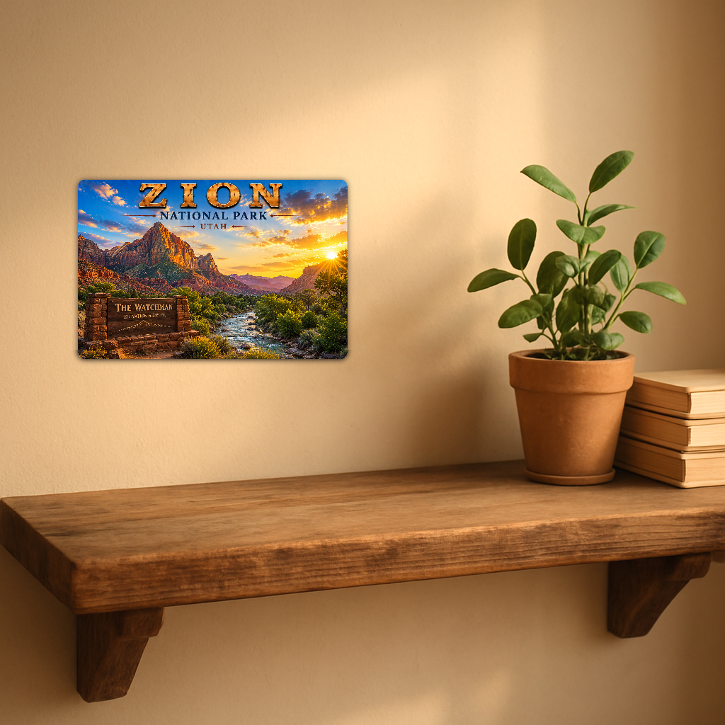 Sign showing Zion The Watchman lettering with a river, red mountain and forest, displayed on a warm beige wall above a rustic shelf with a potted plant and books.