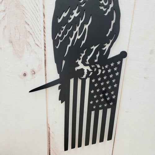Eagle Flag Metal Garden Stake Metal Garden Stake — shown on a rustic wall