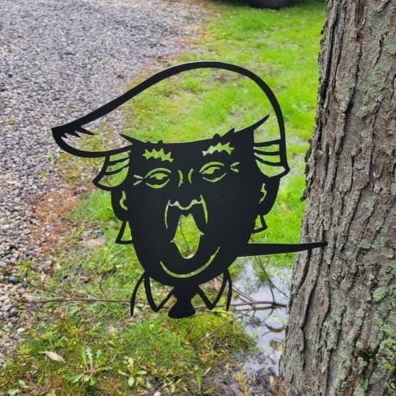 Trump Metal Garden Stake Metal Garden Stake — shown on a rustic wall
