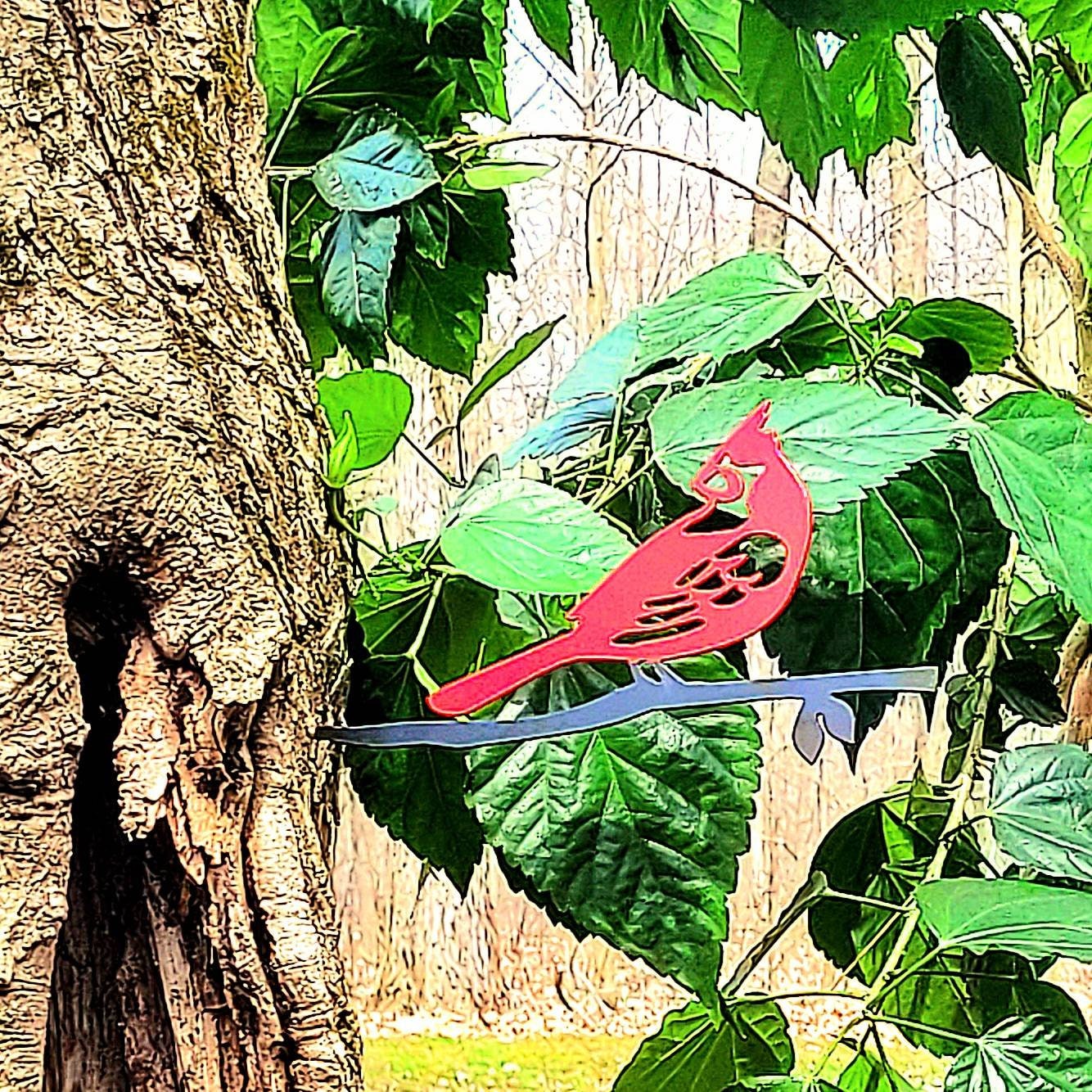 Cardinal Metal Garden Stake Metal Garden Stake — shown on a rustic wall