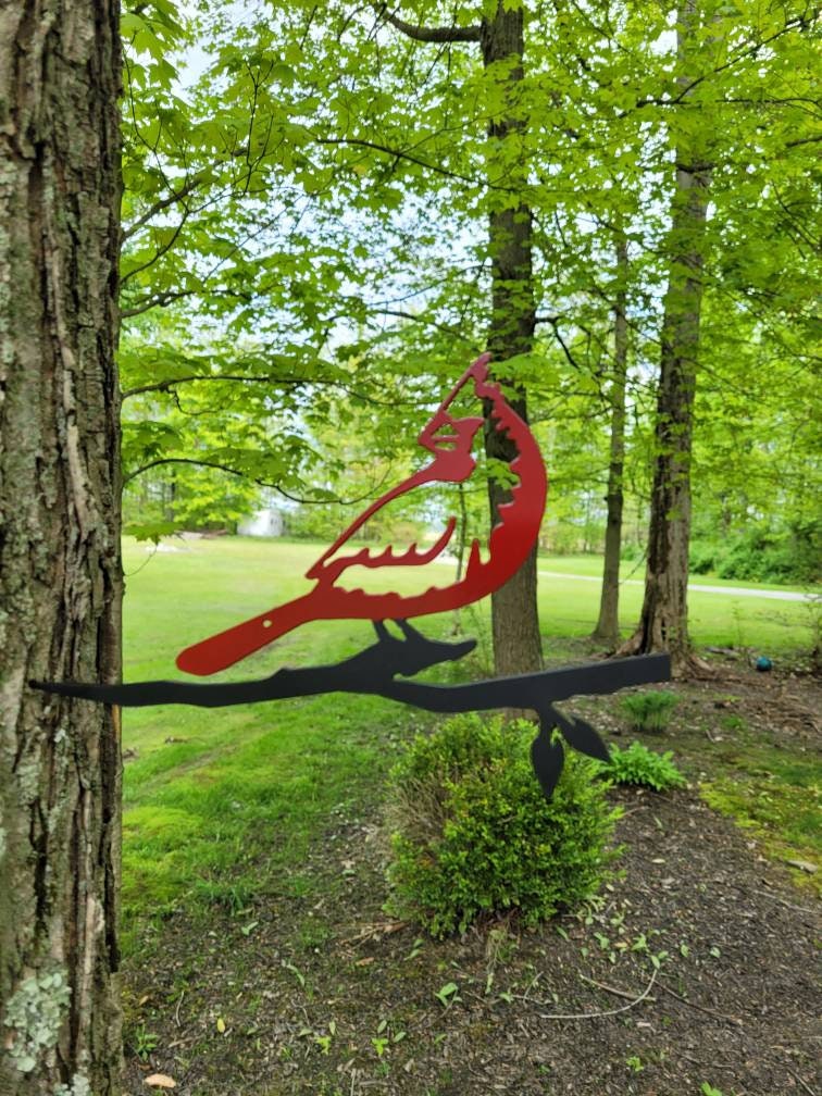 Cardinal Metal Garden Stake Metal Garden Stake — shown on a rustic wall