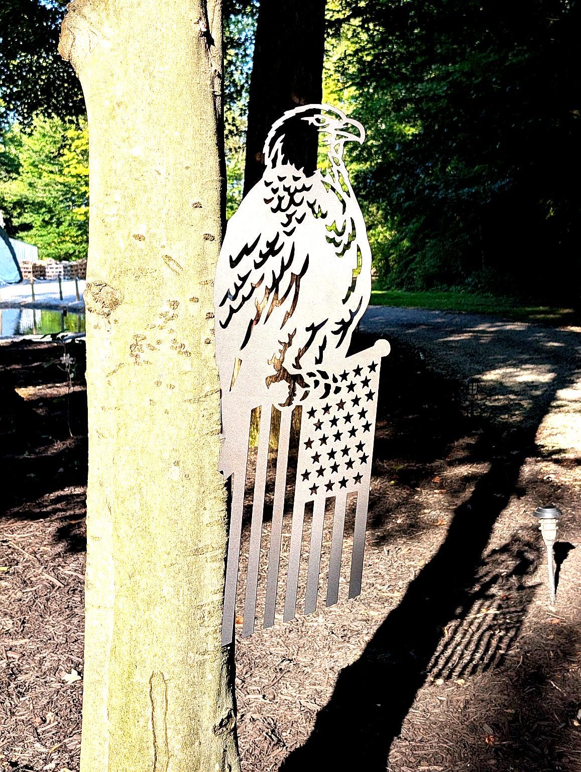 Eagle American Flag Garden Stake Metal Garden Stake — shown on a rustic wall