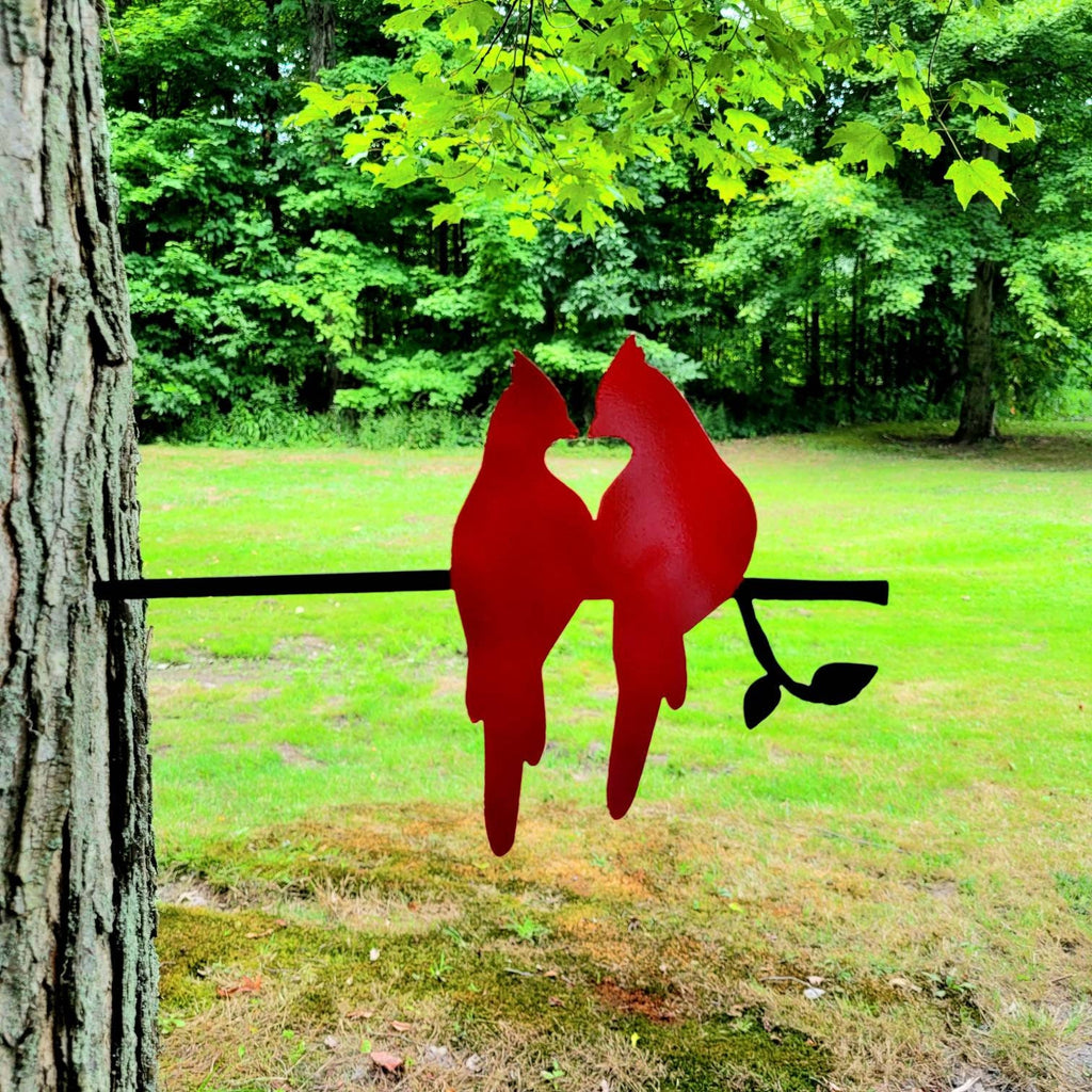 Cardinal Pair Metal Garden Stake Metal Garden Stake — shown on a rustic wall
