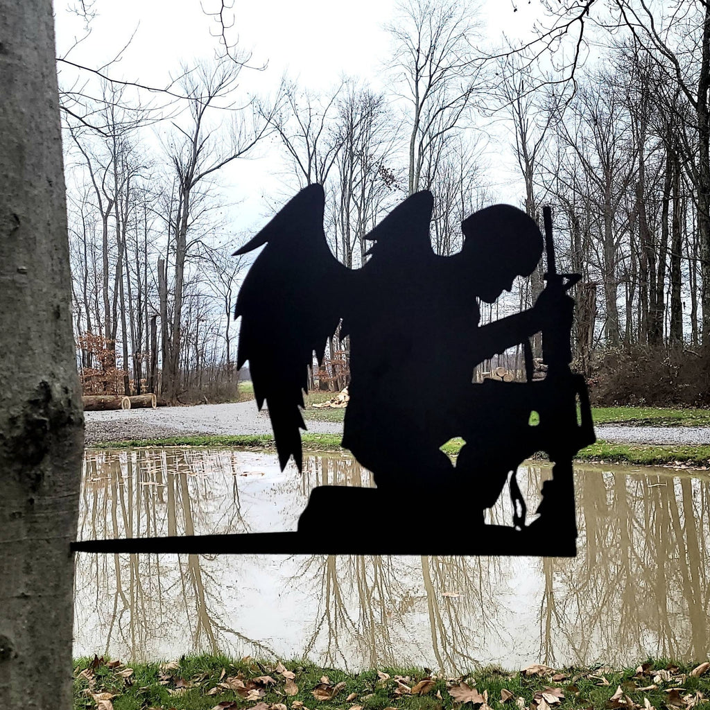 Fallen Soldier Angel Garden Stake Metal Garden Stake — shown on a rustic wall