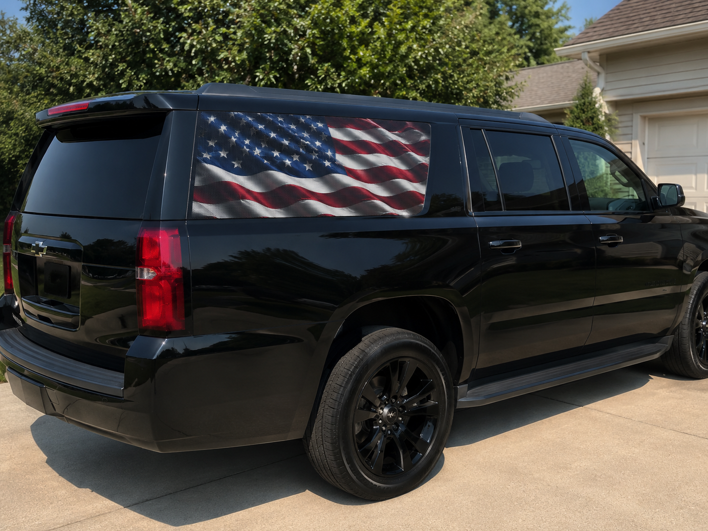 American flag perforated decals on both rear quarter windows of a black SUV