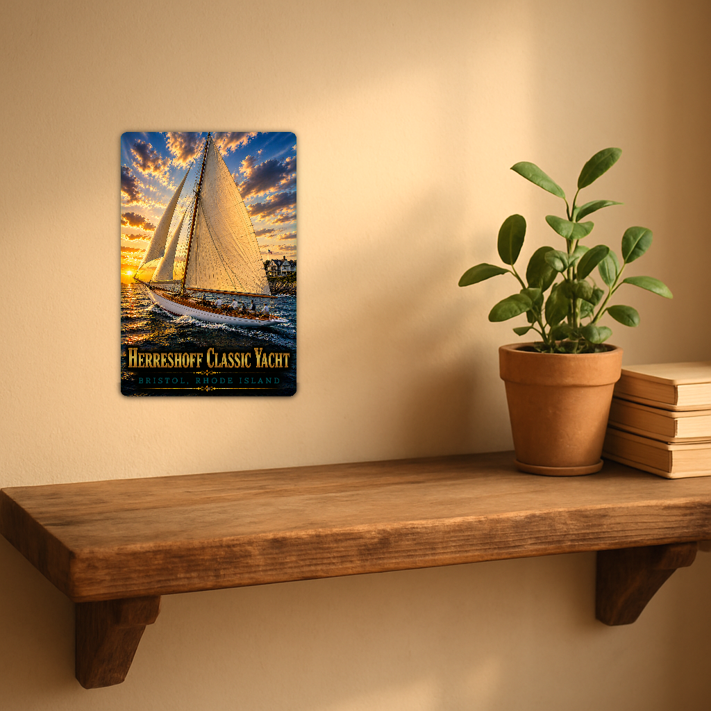 Sign showing Herreshoff Classic Yacht Bristol lettering and people aboard a white-hulled boat with golden sails, displayed on a warm beige wall above a rustic shelf with a potted plant and books.