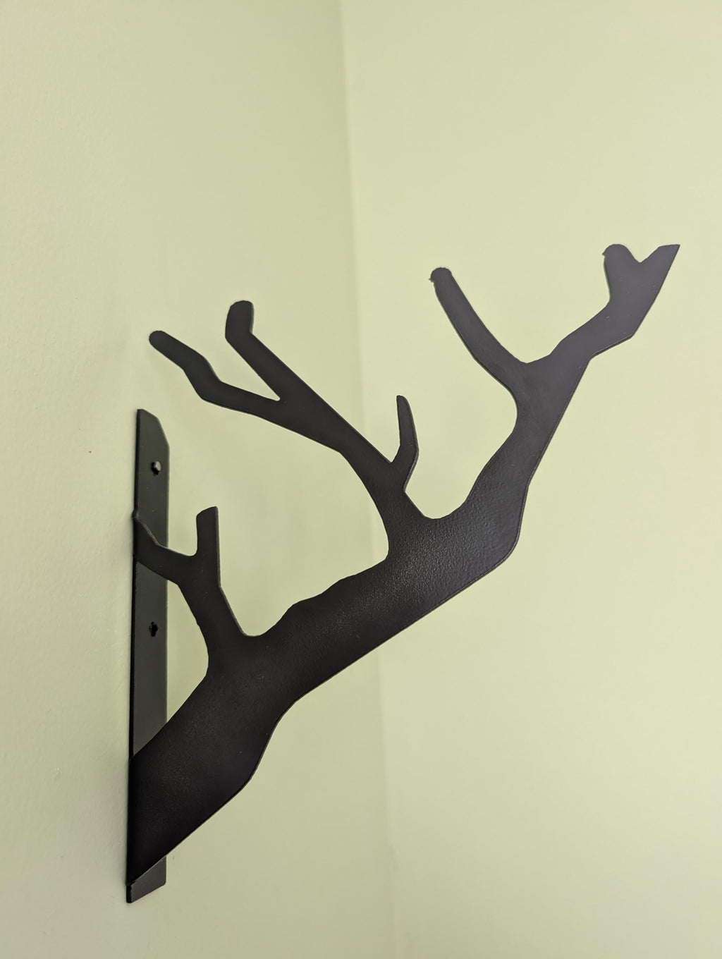 Branch Design Metal Wall Hook Aluminum Sign — shown on a rustic wall