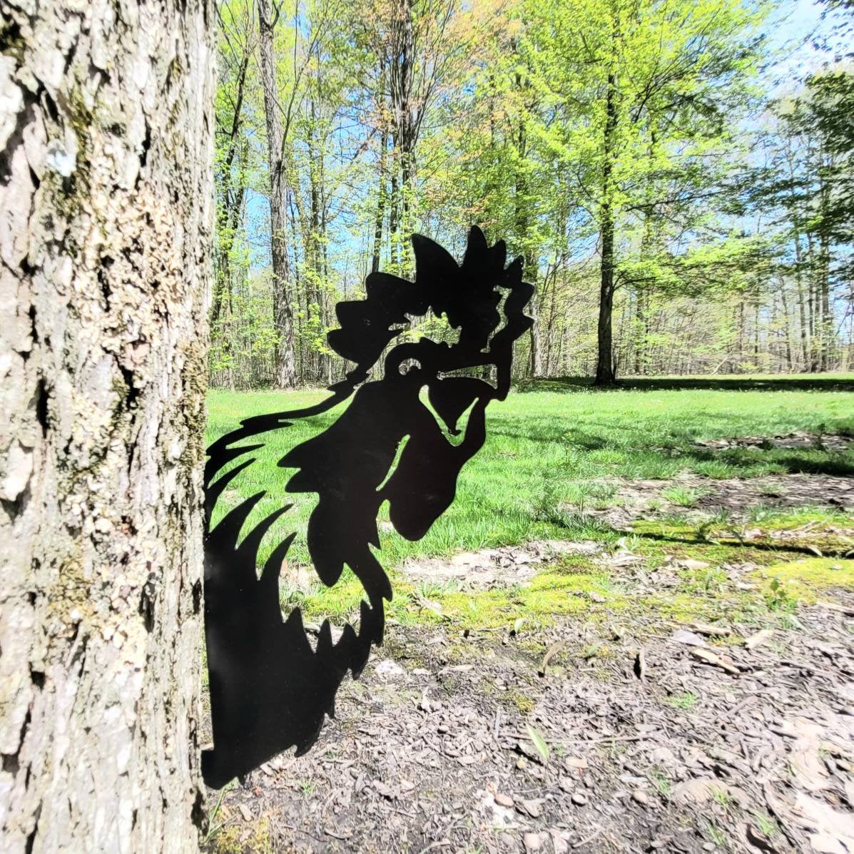 Peeking Rooster Metal Garden Stake Metal Garden Stake — shown on a rustic wall