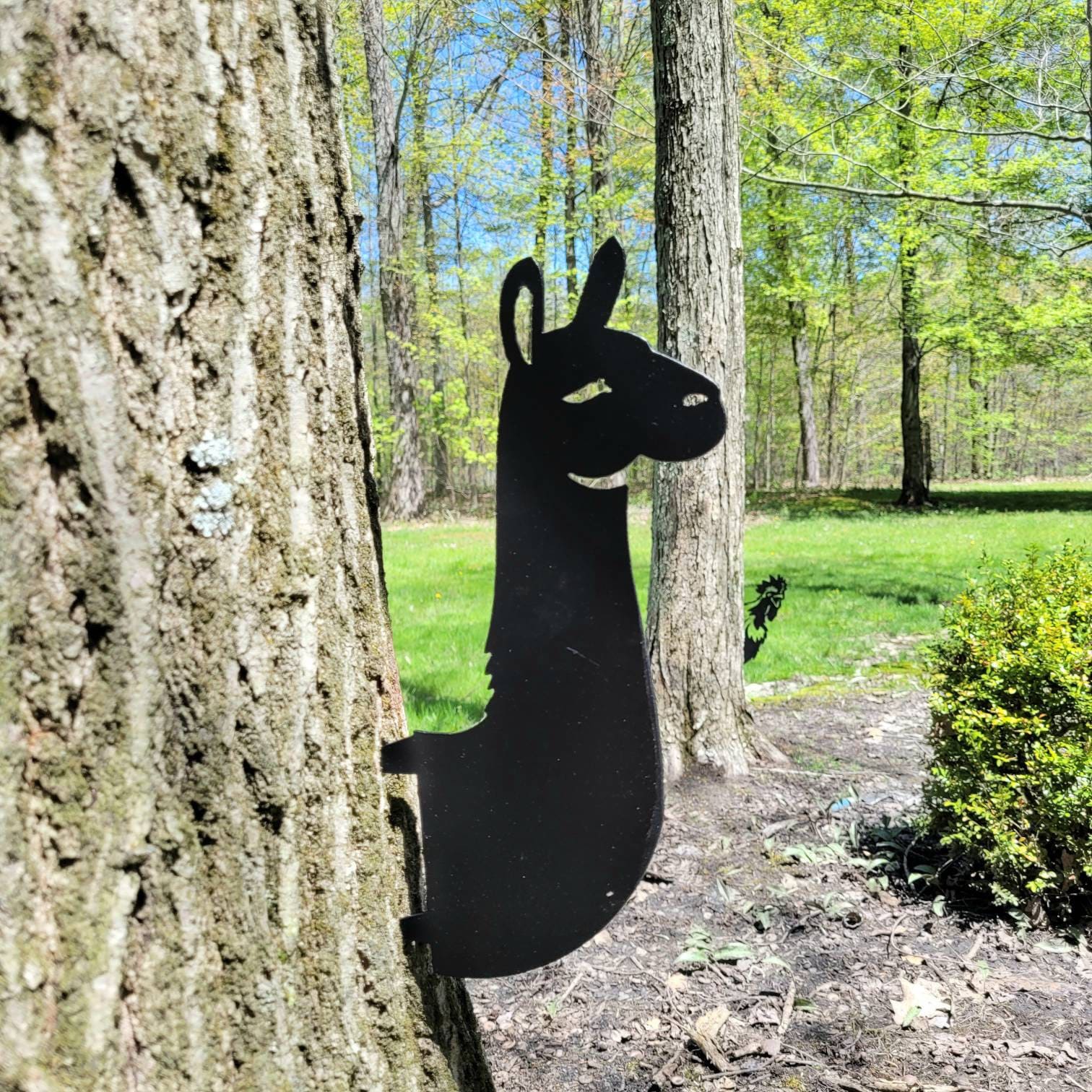 Llama Metal Garden Stake Metal Garden Stake — shown on a rustic wall
