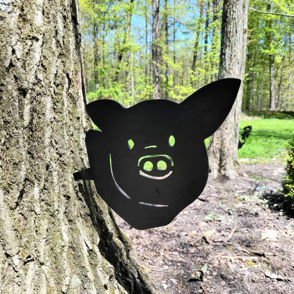 Pig Metal Garden Stake Metal Garden Stake — shown on a rustic wall