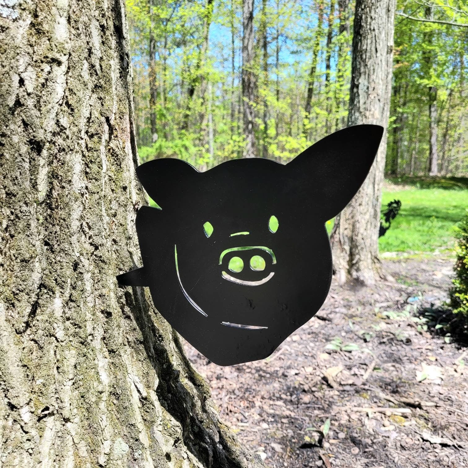 Pig Metal Garden Stake Metal Garden Stake — shown on a rustic wall