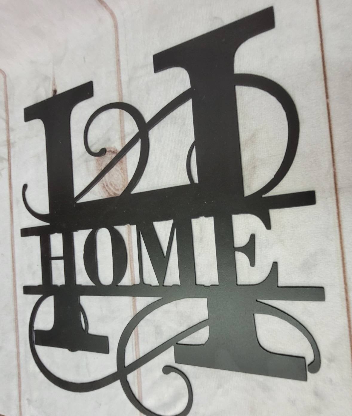 Home Split Letter Monogram Aluminum Sign — shown on a rustic wall