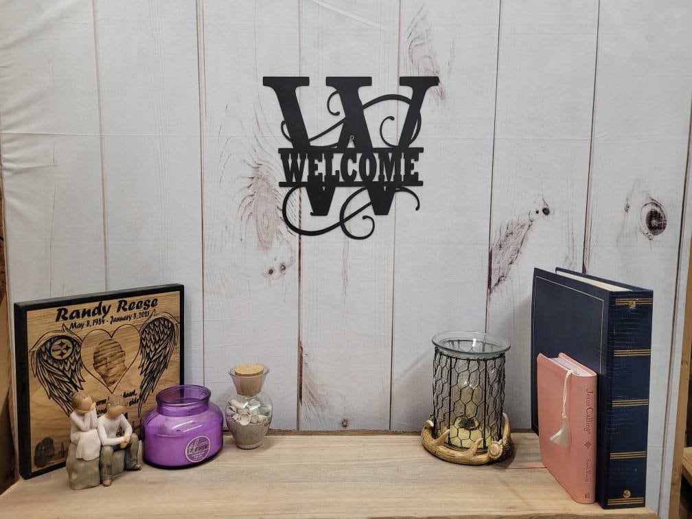 Welcome Split Letter Monogram Aluminum Sign — shown on a rustic wall