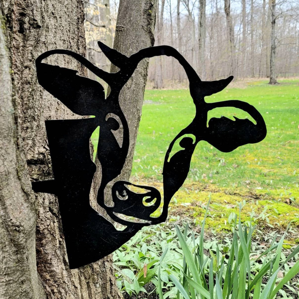 Peeking Cow Metal Garden Stake Metal Garden Stake — shown on a rustic wall