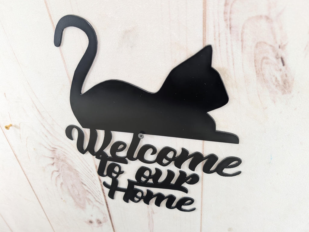 Cat Welcome Sign Aluminum Sign — shown on a rustic wall