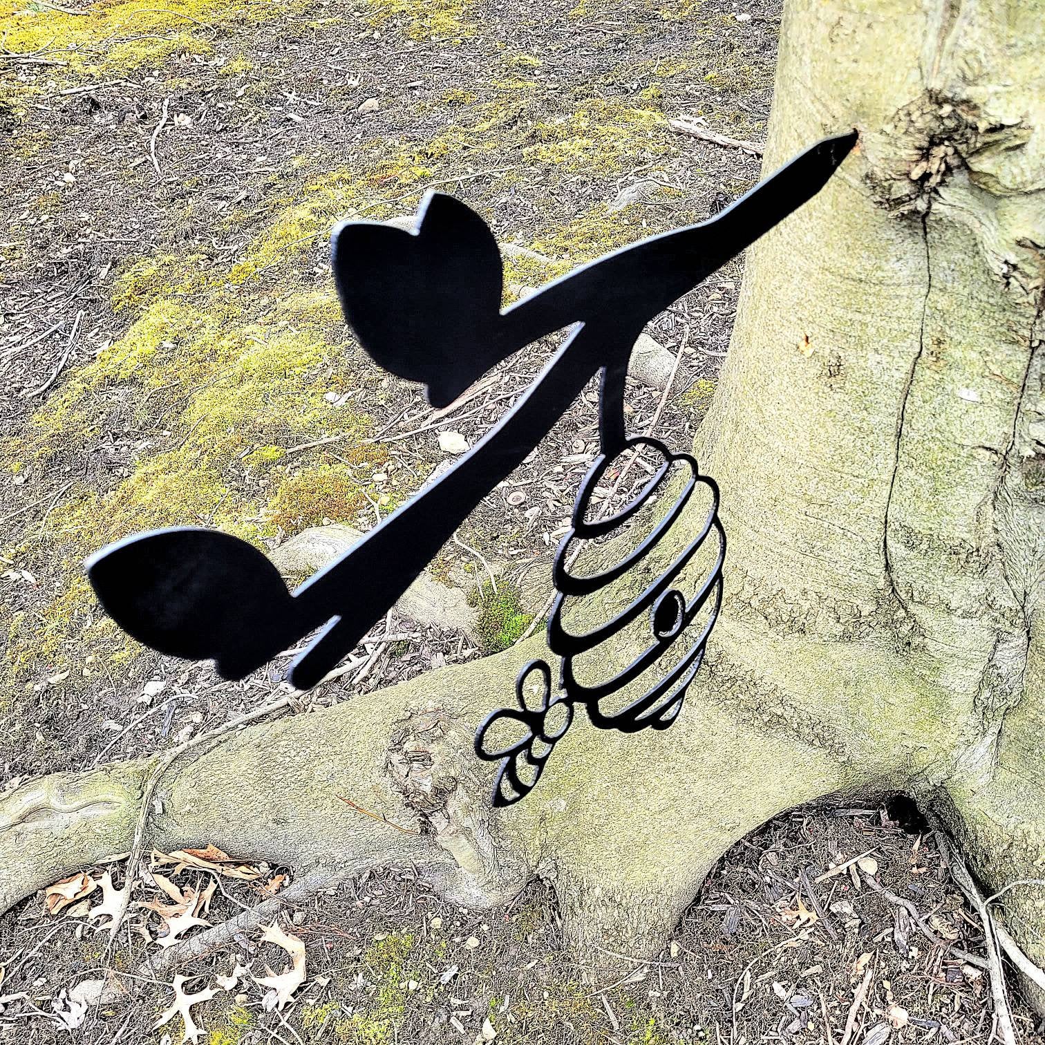 Beehive Metal Garden Stake Metal Garden Stake — shown on a rustic wall