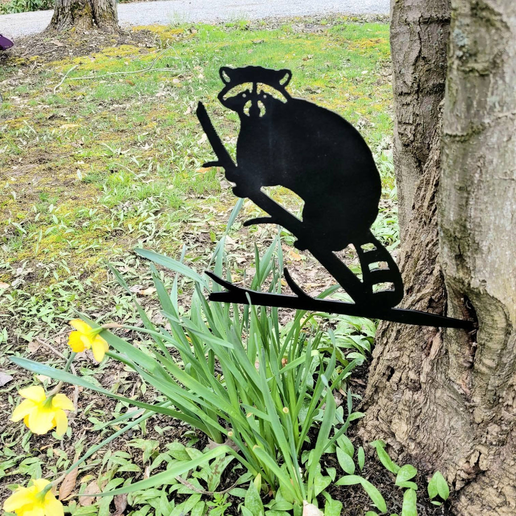 Raccoon Metal Garden Stake Metal Garden Stake — shown on a rustic wall