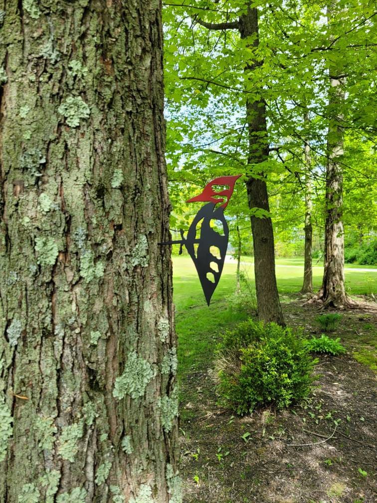 Woodpecker Metal Garden Stake Metal Garden Stake — shown on a rustic wall