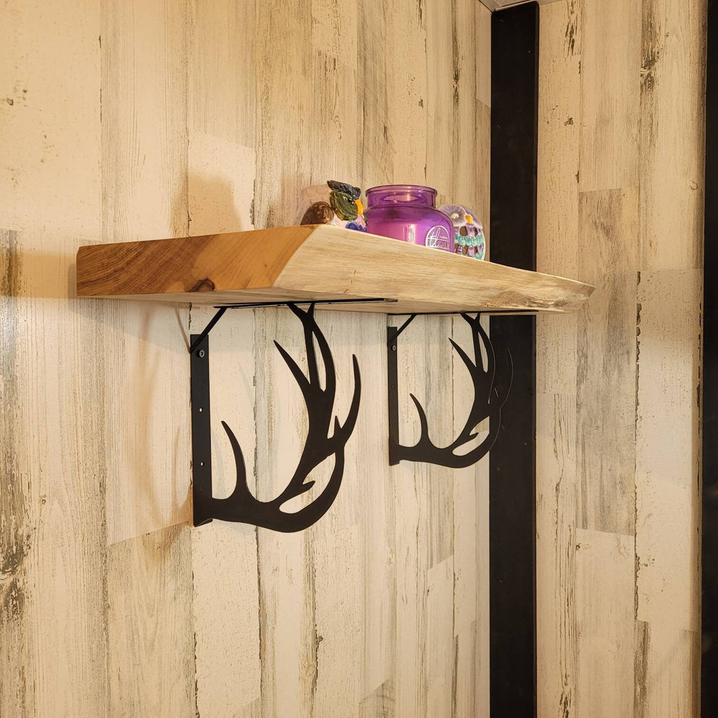 Buck Antler Shelf Bracket Set Metal Shelf Bracket — shown on a rustic wall