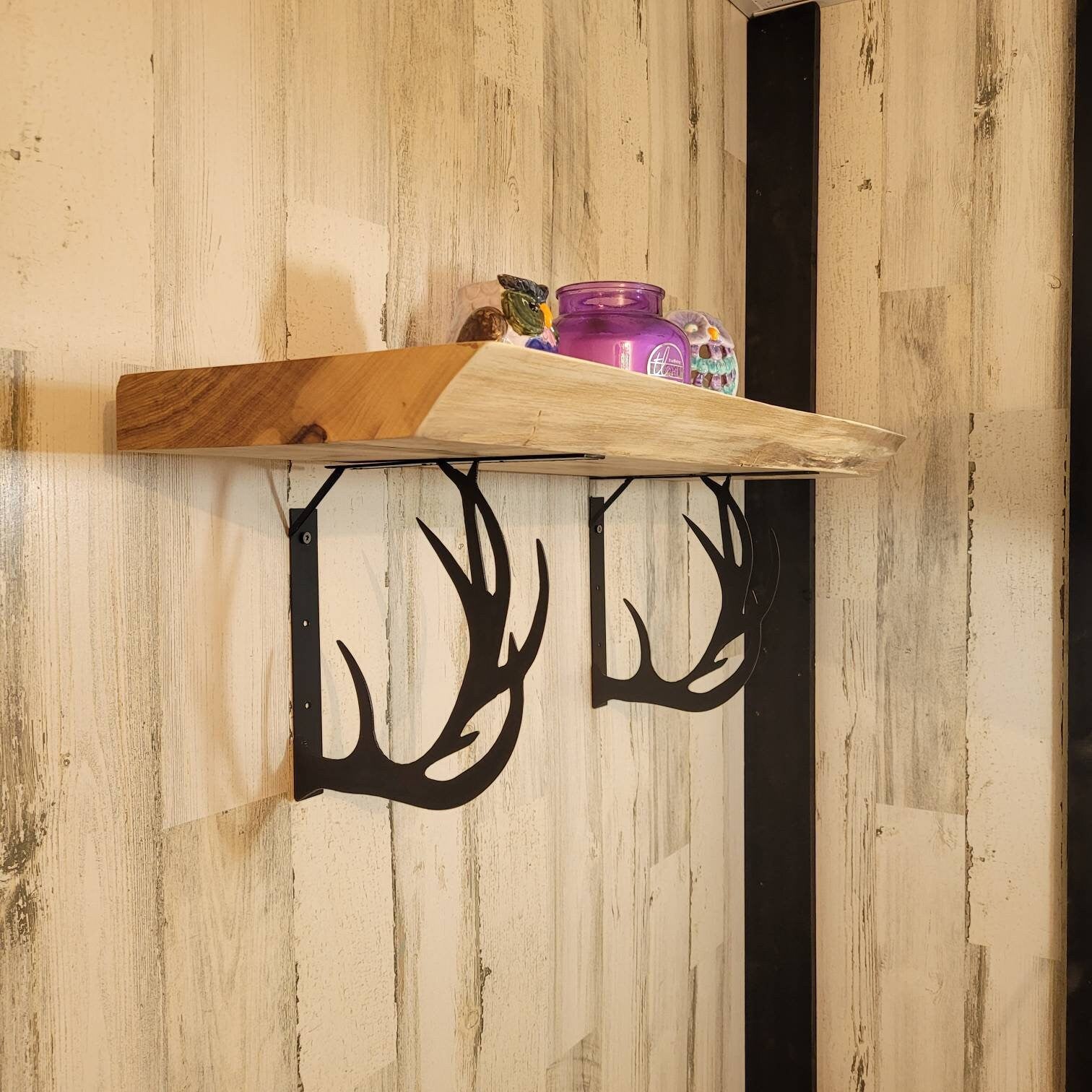 Buck Antler Shelf Bracket Set Metal Shelf Bracket — shown on a rustic wall