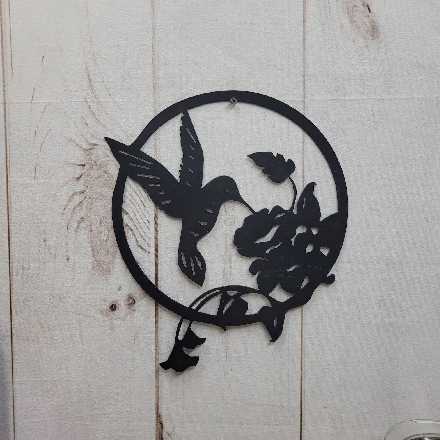 Hummingbird Metal Wall Art Metal Garden Stake — shown on a rustic wall
