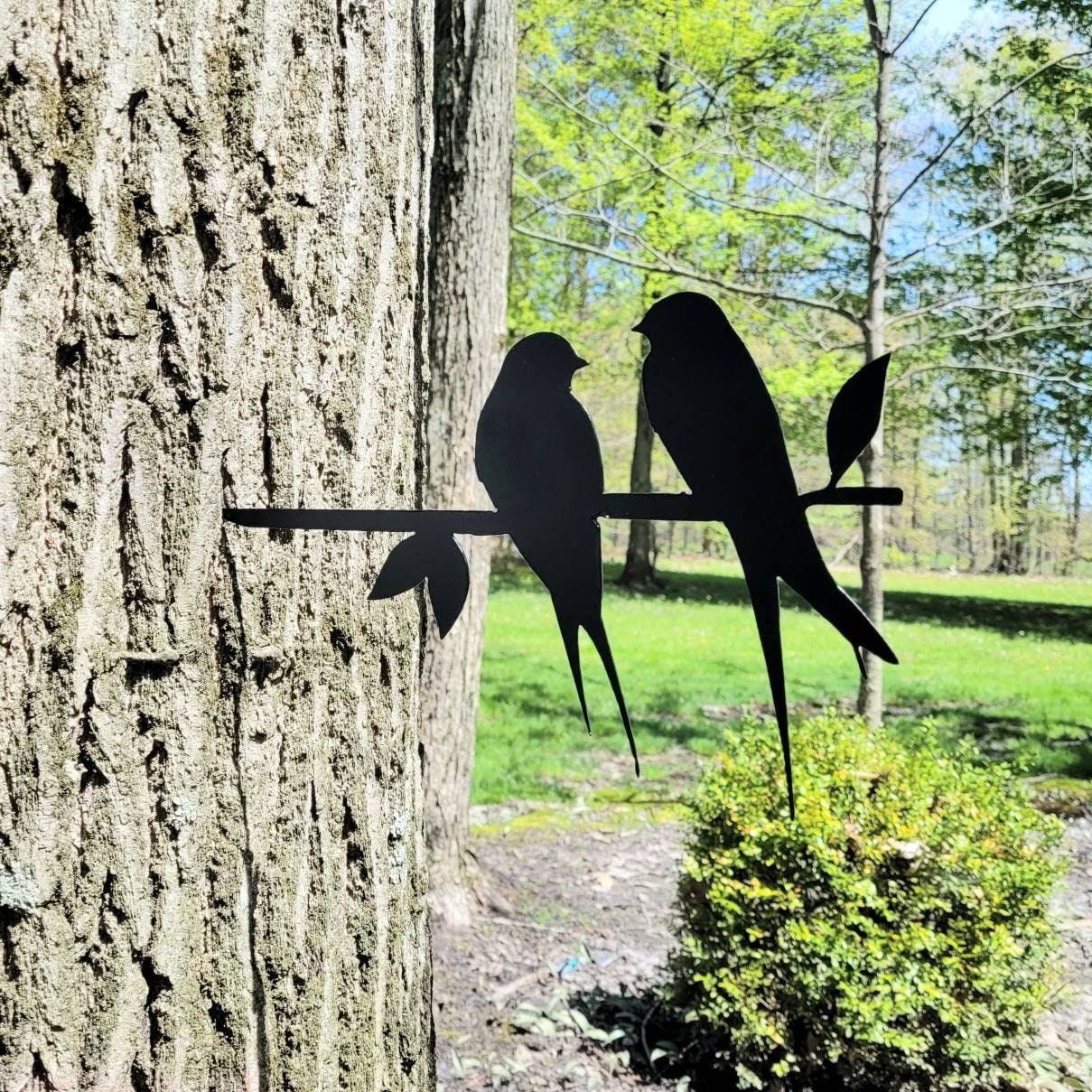 Love Birds Metal Garden Stake Metal Garden Stake — shown on a rustic wall