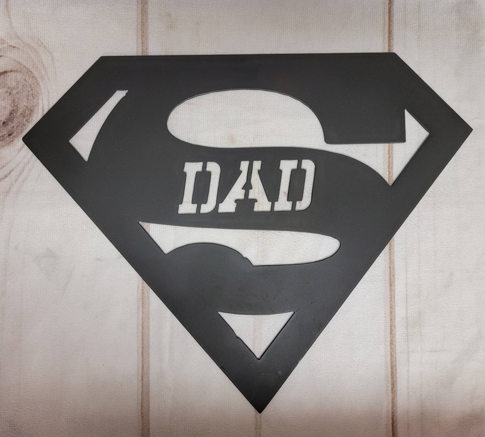 Super Dad Metal Wall Art Aluminum Sign — shown on a rustic wall