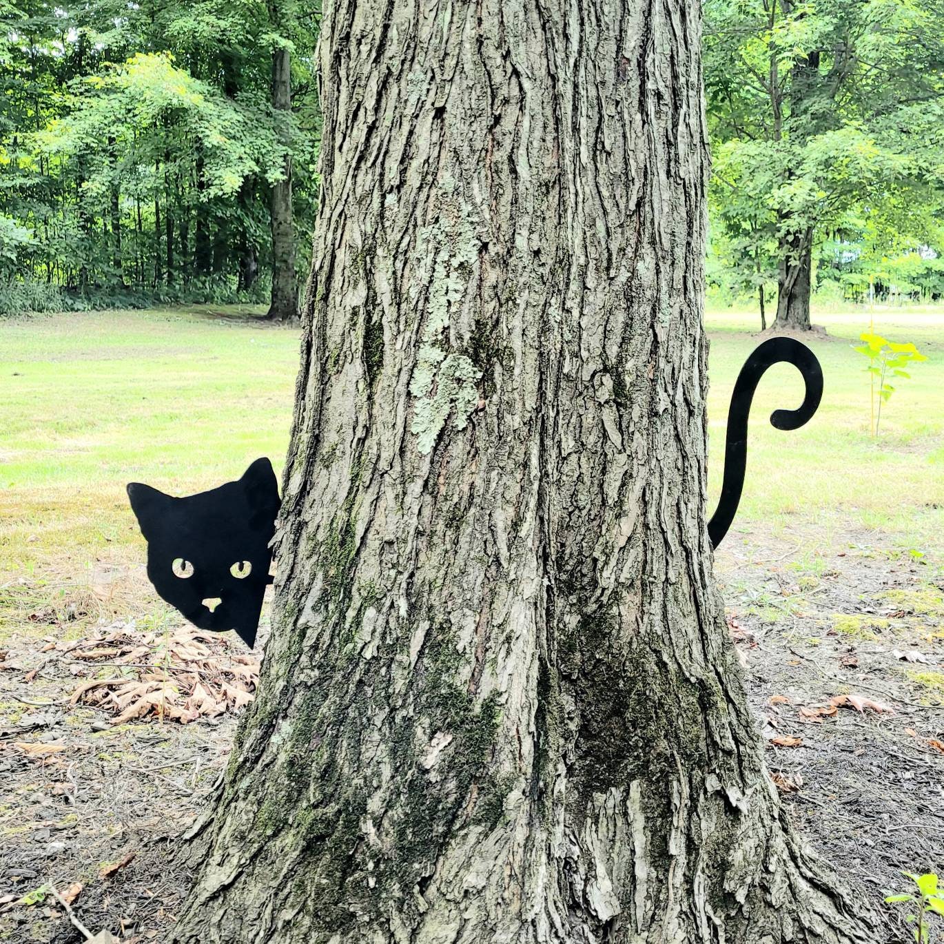 Black Cat Metal Garden Stake Metal Garden Stake — shown on a rustic wall