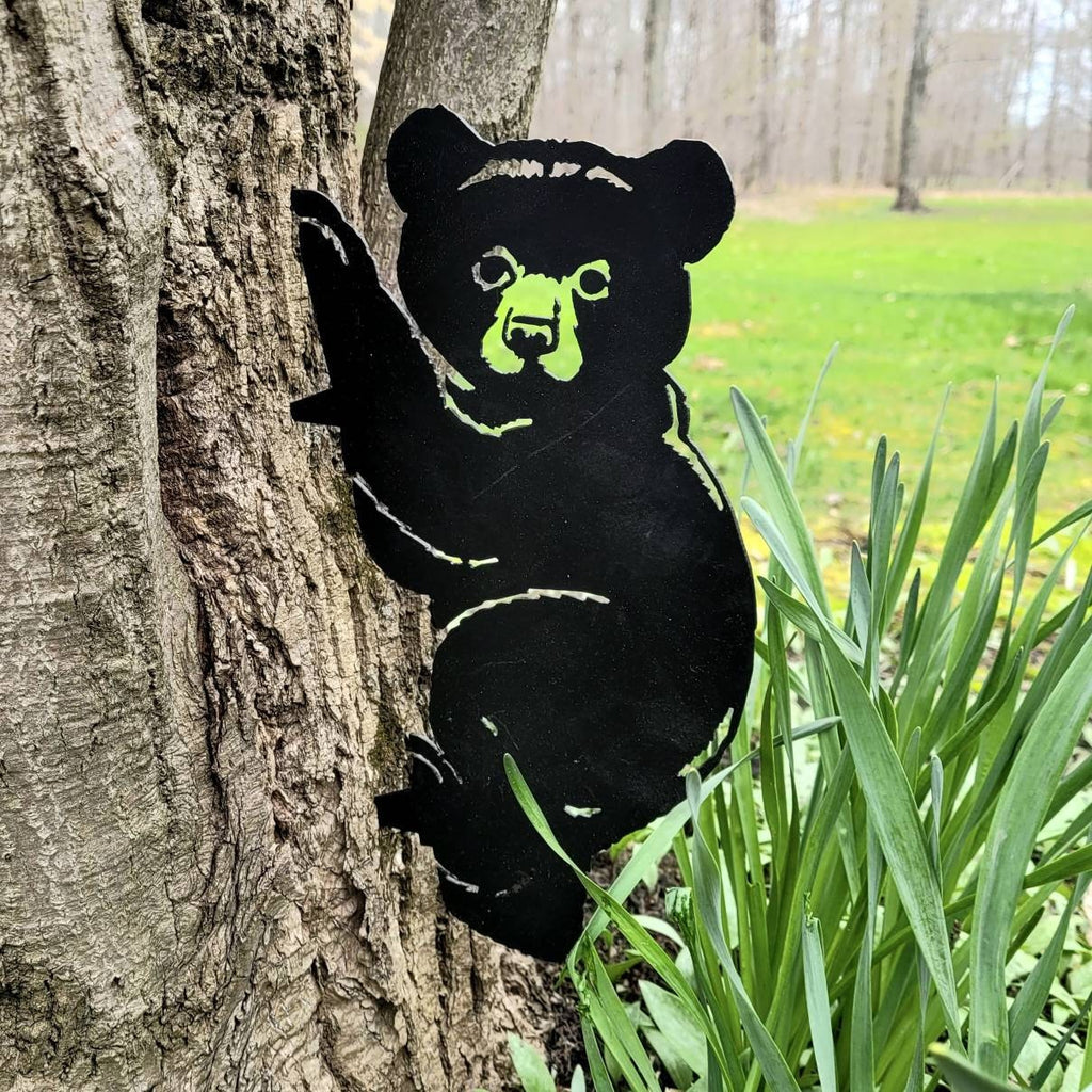 Black Bear Cub Metal Garden Stake Metal Garden Stake — shown on a rustic wall