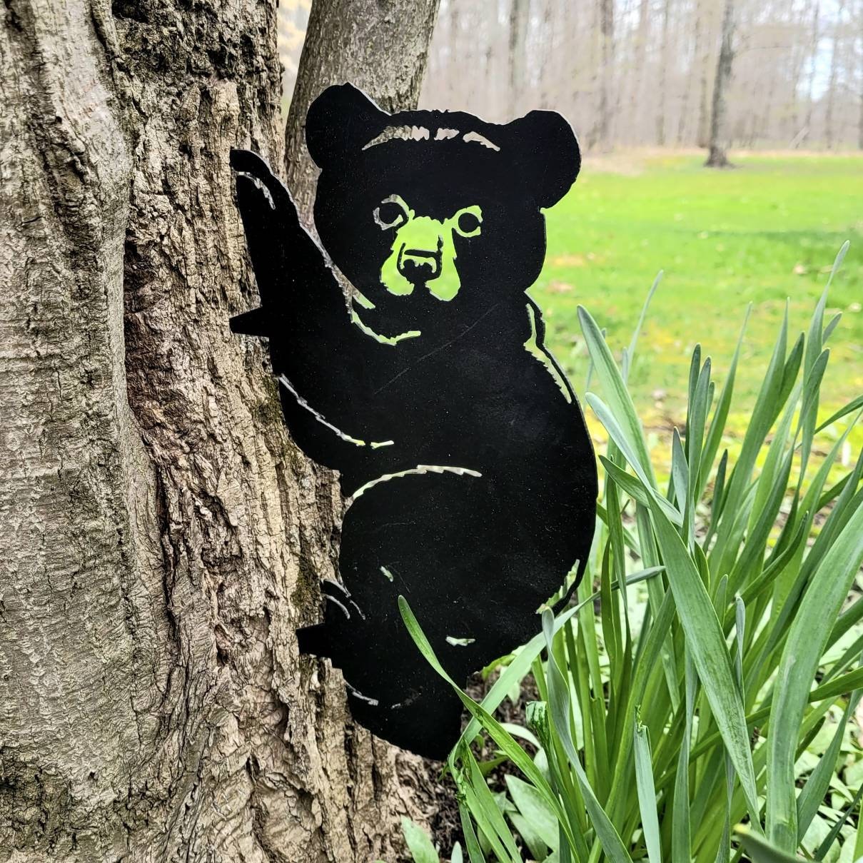 Black Bear Cub Metal Garden Stake Metal Garden Stake — shown on a rustic wall