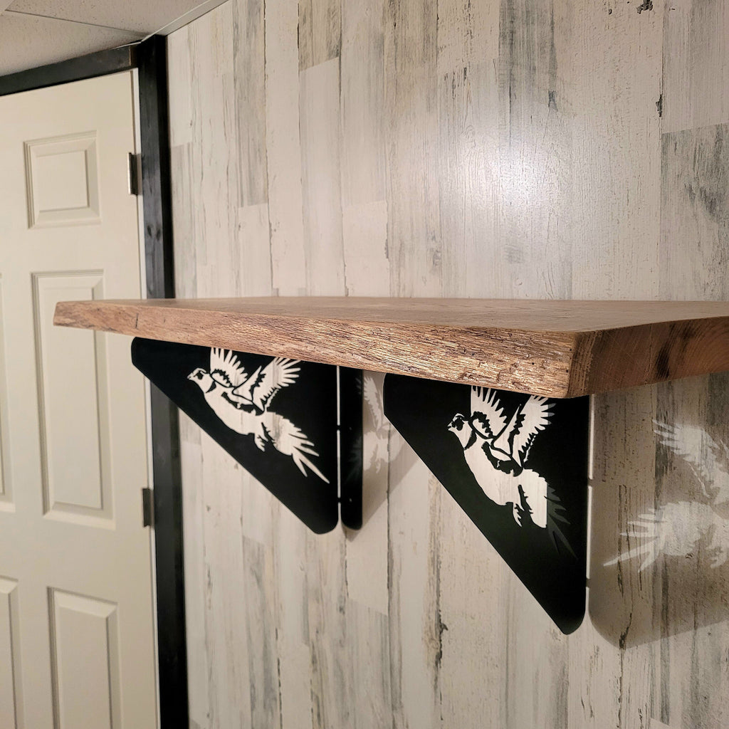 Pheasant Shelf Bracket Metal Shelf Bracket — shown on a rustic wall