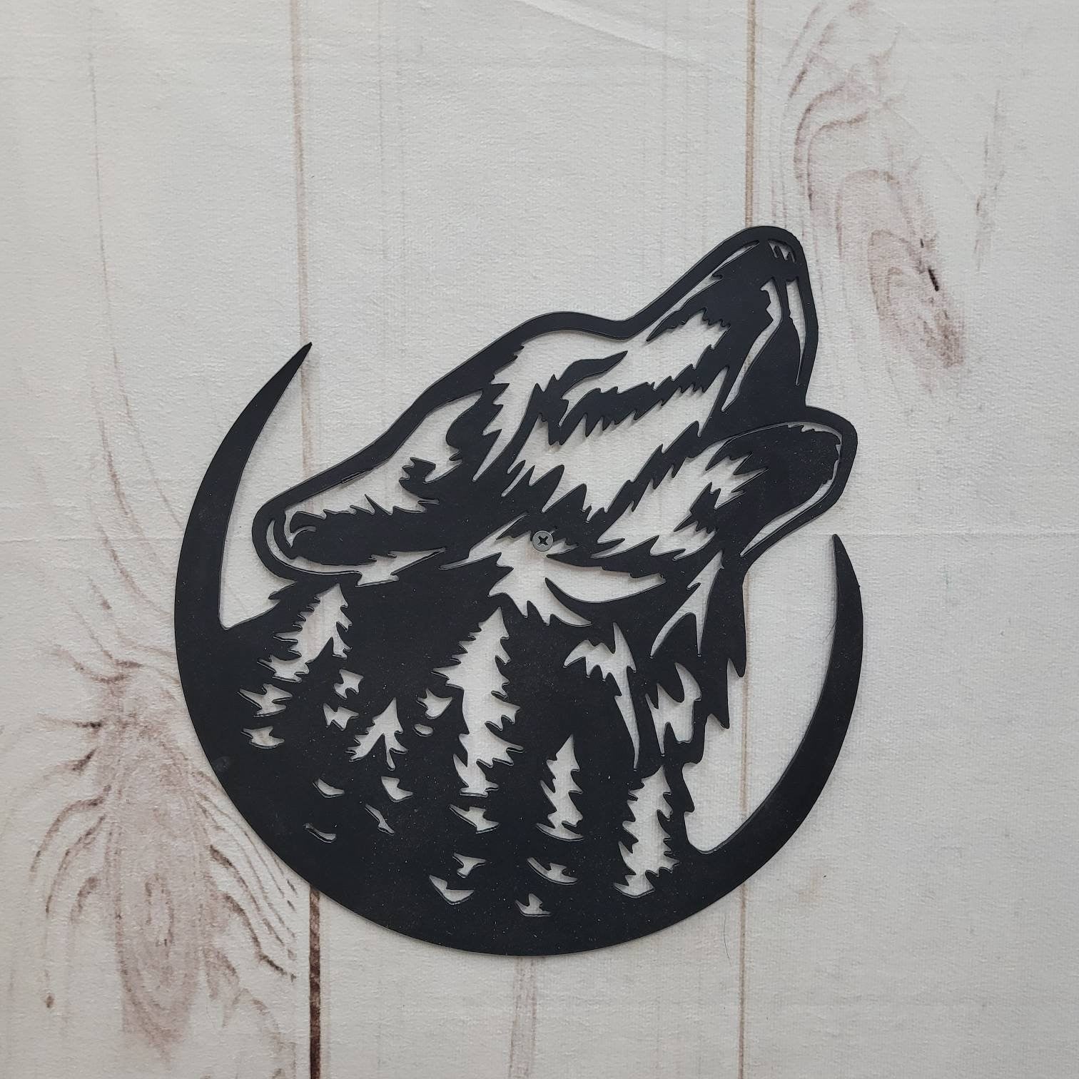 Howling Wolf Metal Wall Art Aluminum Sign — shown on a rustic wall