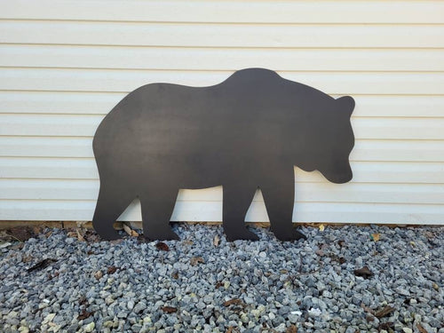 Bear Metal Yard Stake Metal Garden Stake — shown on a rustic wall