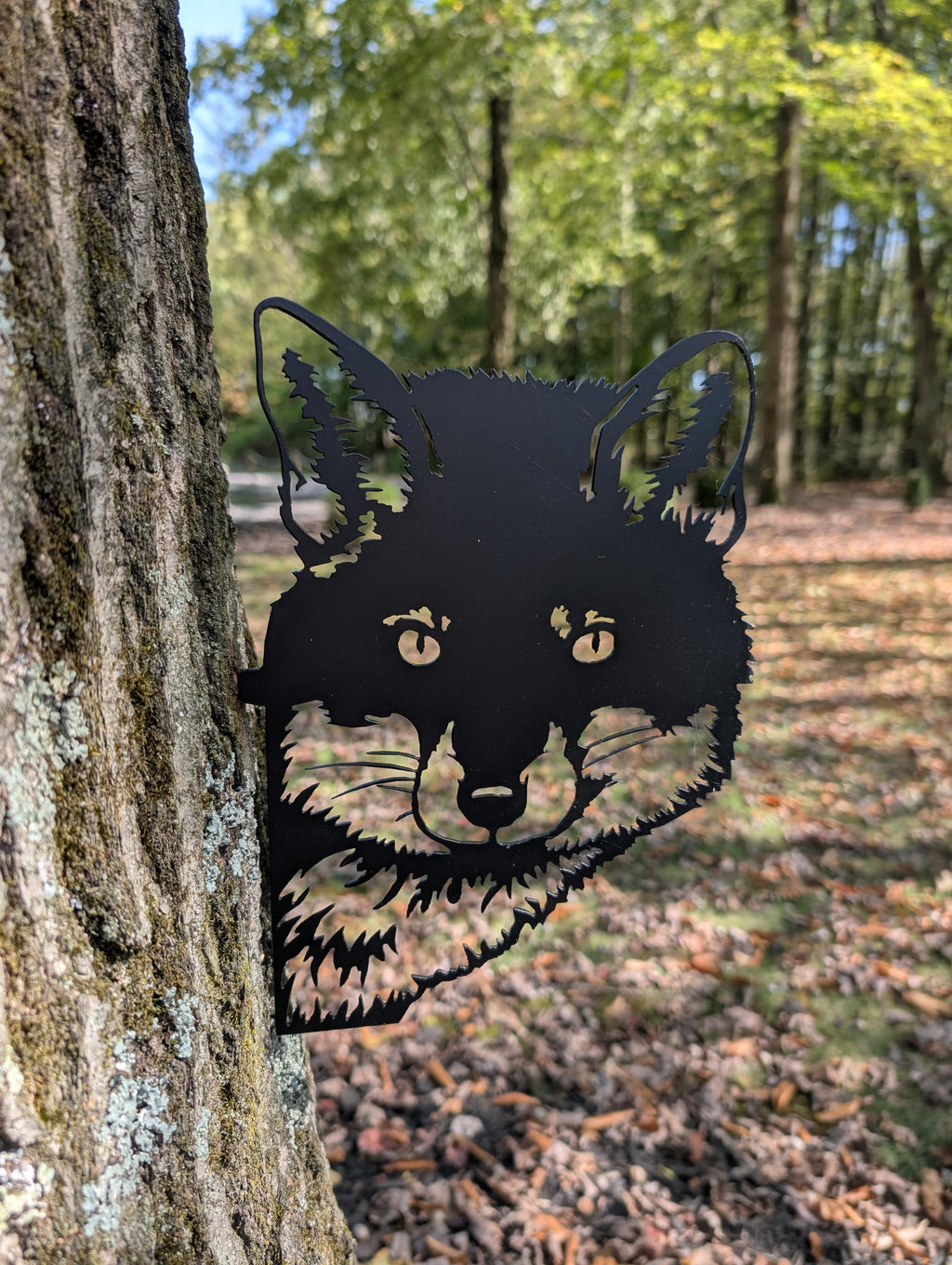 Peeking Fox Metal Yard Stake Metal Garden Stake — shown on a rustic wall