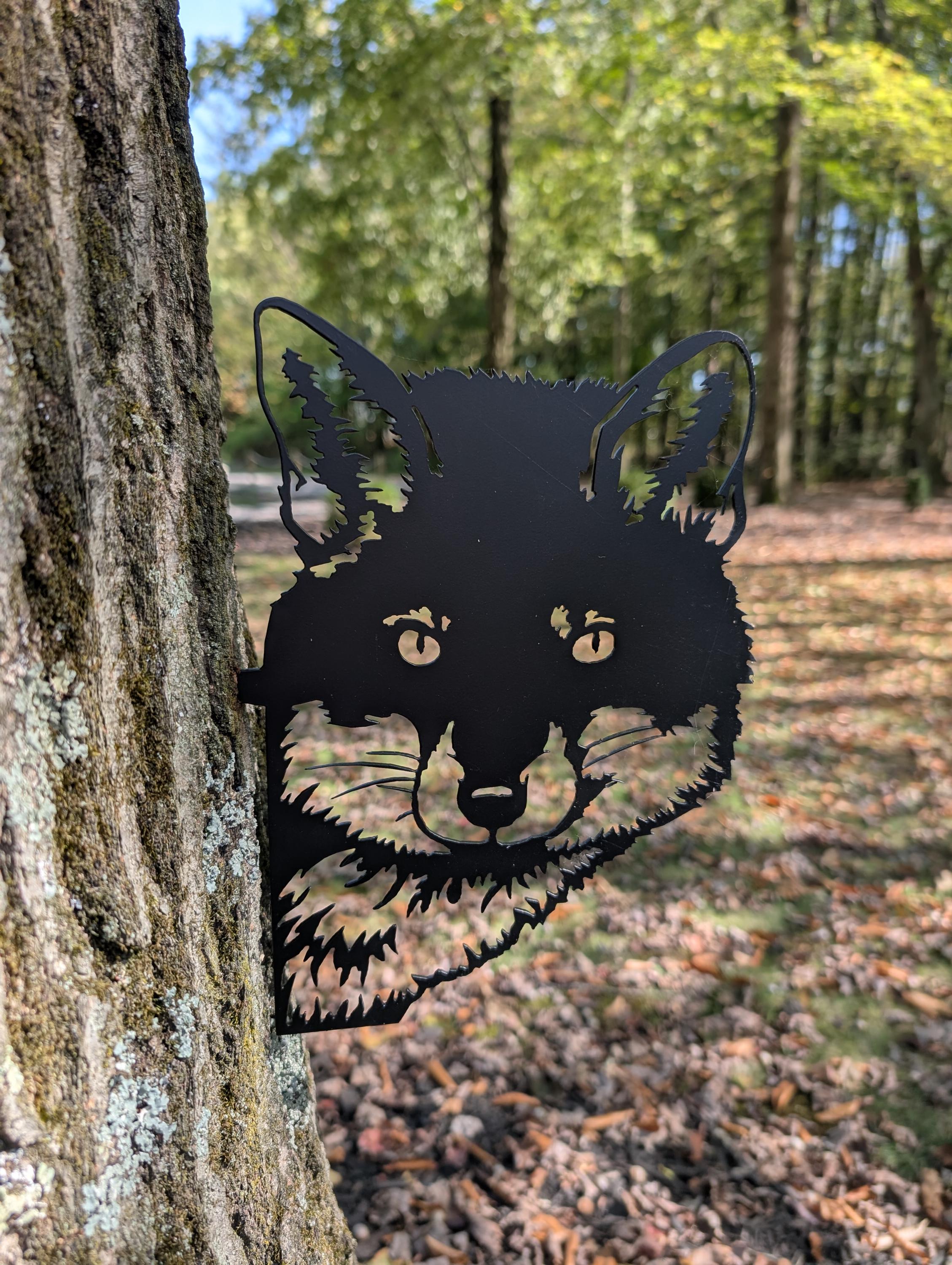 Peeking Fox Metal Yard Stake Metal Garden Stake — shown on a rustic wall