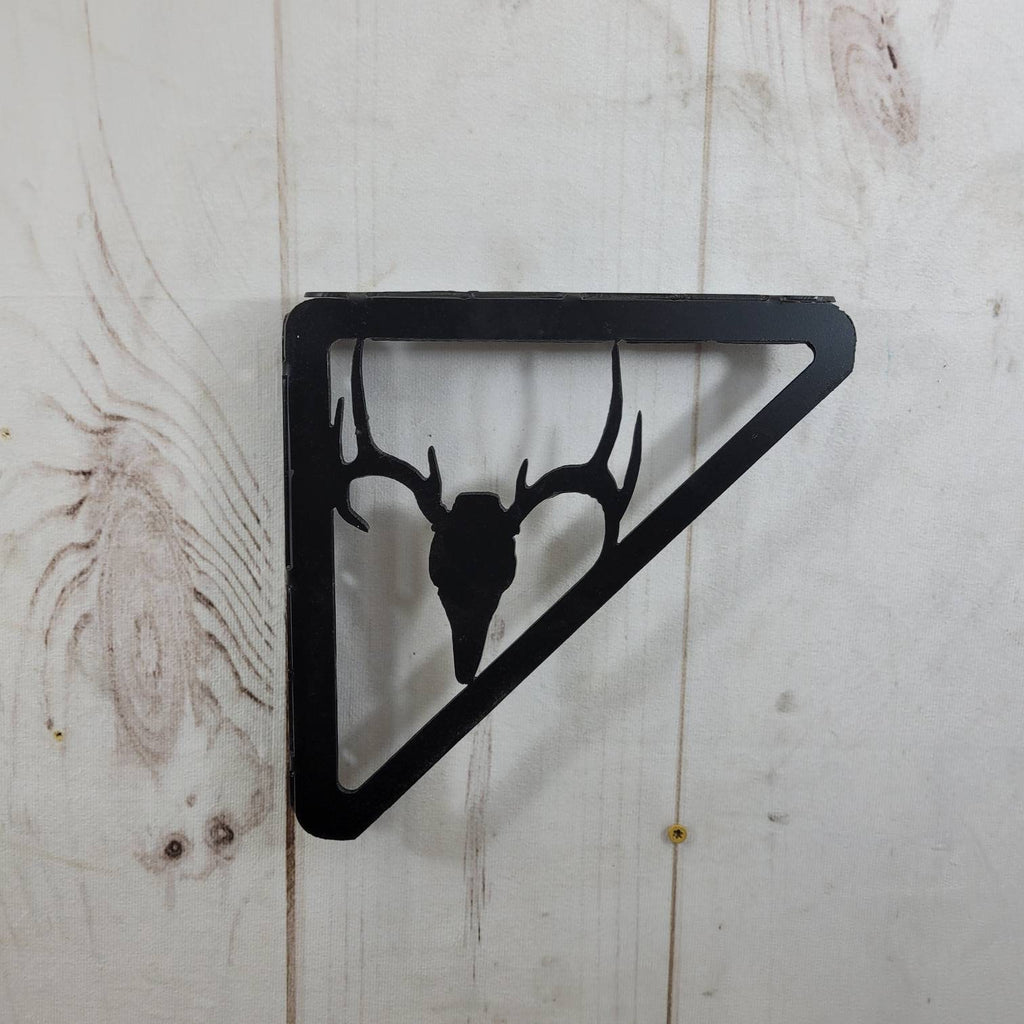 Buck Skull Shelf Bracket Metal Shelf Bracket — shown on a rustic wall
