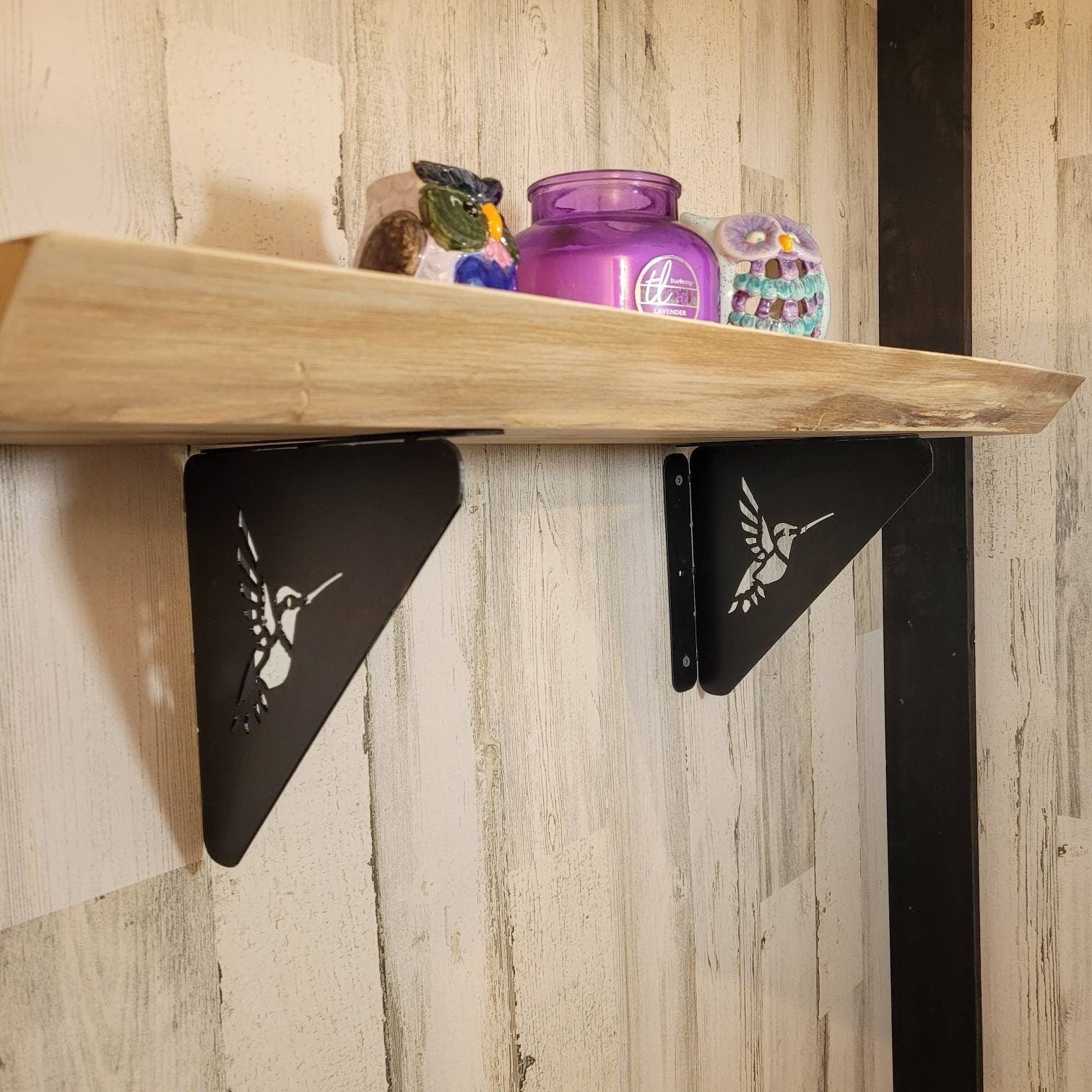 Hummingbird Shelf Bracket Metal Shelf Bracket — shown on a rustic wall