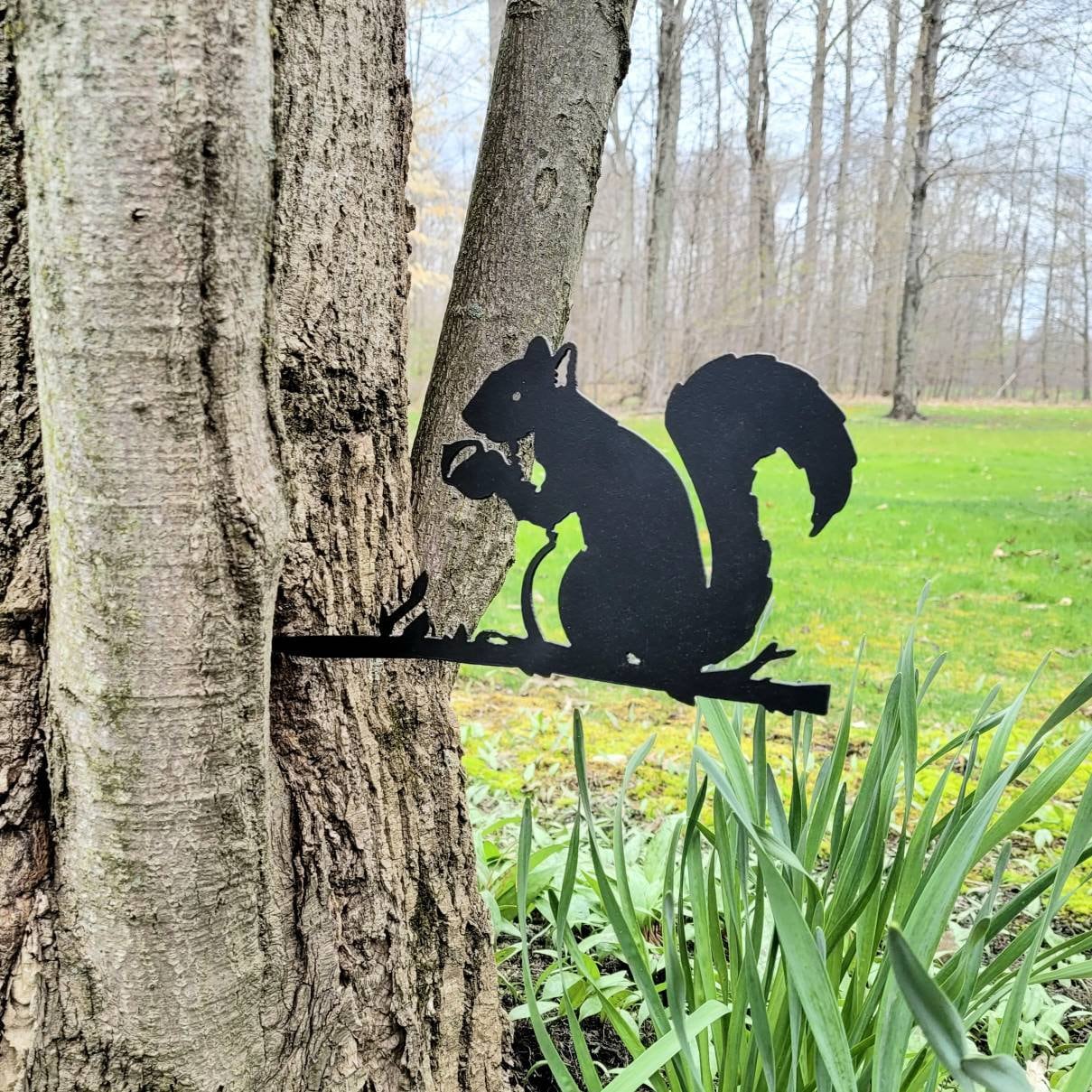 Squirrel Metal Garden Stake Metal Garden Stake — shown on a rustic wall