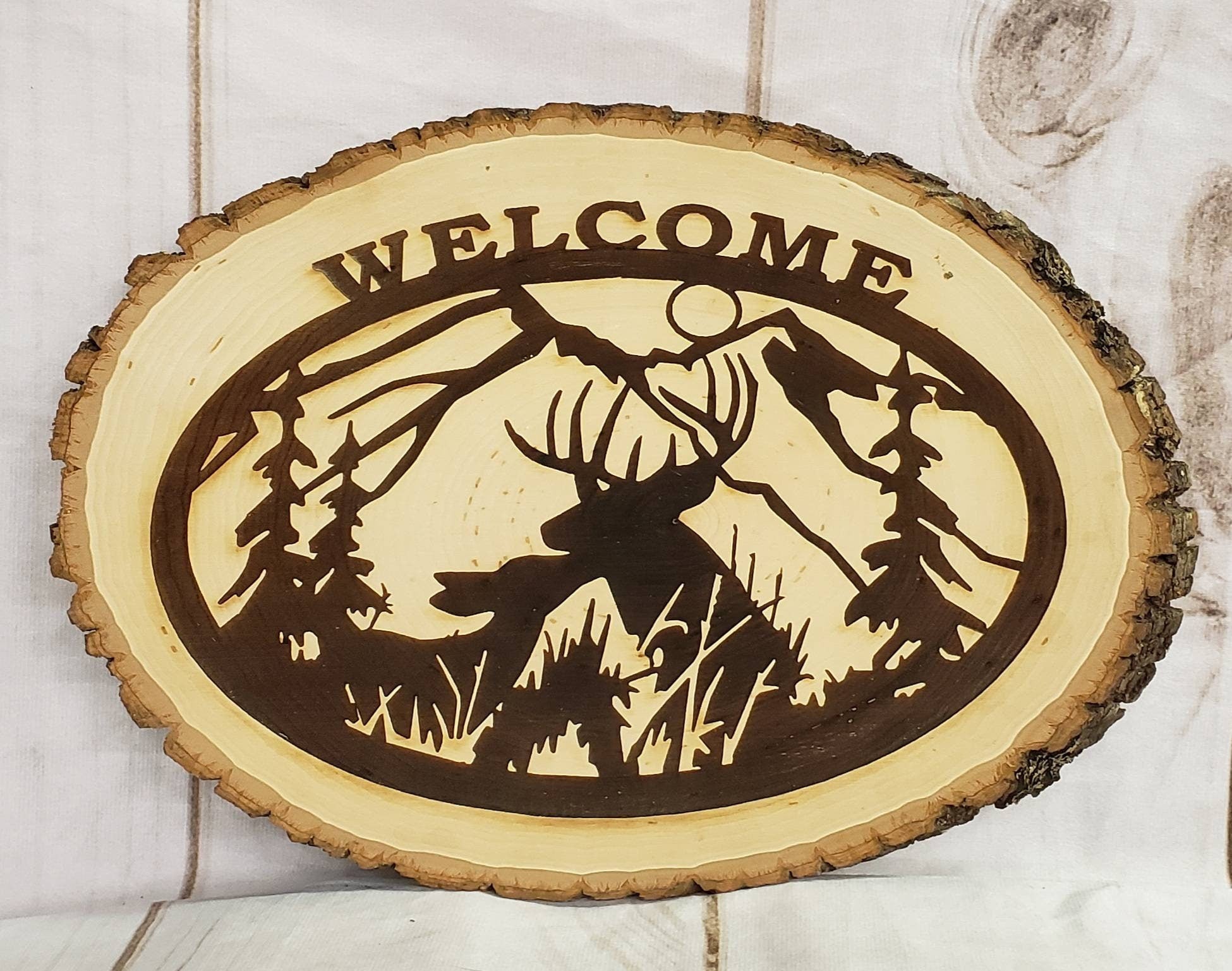 Live Edge Deer Welcome Sign Wood Sign — shown on a rustic wall